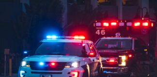 Police car and ambulance with flashing lights nighttime