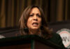 Kamala Harris Gets First Shot at THIS? A woman speaking at a podium, looking serious.