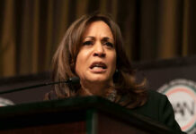 Kamala Harris Gets First Shot at THIS? A woman speaking at a podium, looking serious.