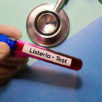 Walmart Soup Scare: Listeria Alert A gloved hand holding a blood test tube labeled 'Listeria - Test'