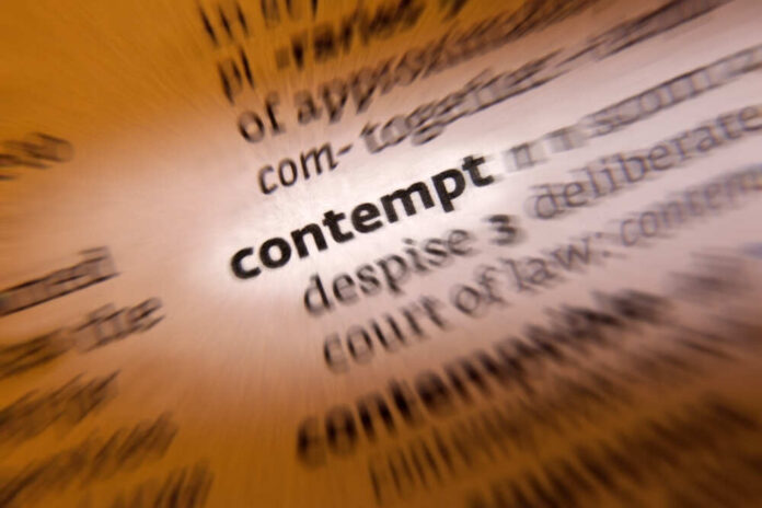 Contempt,-,The,Feeling,That,A,Person,Or,A,Thing Blurred dictionary entry focusing on the word 'contempt'