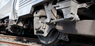 Close-up view of a train wheel on railway tracks
