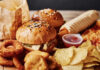 Fast-Food Deal Mania Hits 50-Year High A variety of fast food items including burgers, onion rings, and chips