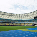 Graduation Turns Deadly — Mass Casualty Event Empty stadium with blue running track and green field