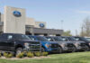 Ford dealership with trucks lined up outside