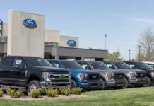 Hands-Free Hauling? Famed Pickup Pushes 10,000 Pounds Ford dealership with trucks lined up outside