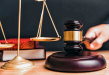 Courthouse Bust BLOWS UP Murder Trial Judge gavel, scales of justice, and law books.
