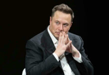 Shock Win: Musk Thanks Far Right Elon Musk in suit thinking.