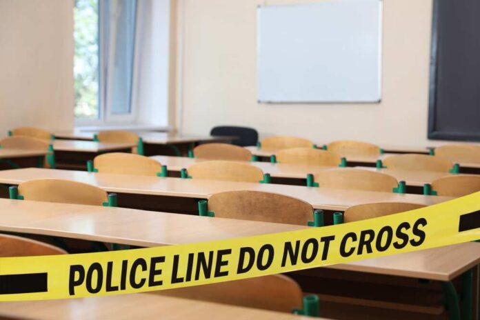 Yellow,Crime,Scene,Tape,In,Empty,School,Classroom Empty classroom blocked by police tape