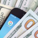 FaceTime Scam Empties Bank Accounts Smartphone with Google app on screen among US dollar bills