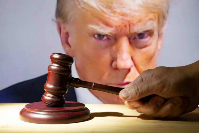 shutterstock_2362003039 Donald Trump behind a judge’s gavel held by a hand