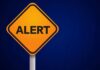 Travel Alert: Threat Spike Brings U.S. Warning Orange alert sign with the word 'ALERT' displayed prominently