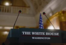 White House Door Slammed Shut – Judges Step In? Podium with microphones in a formal government setting