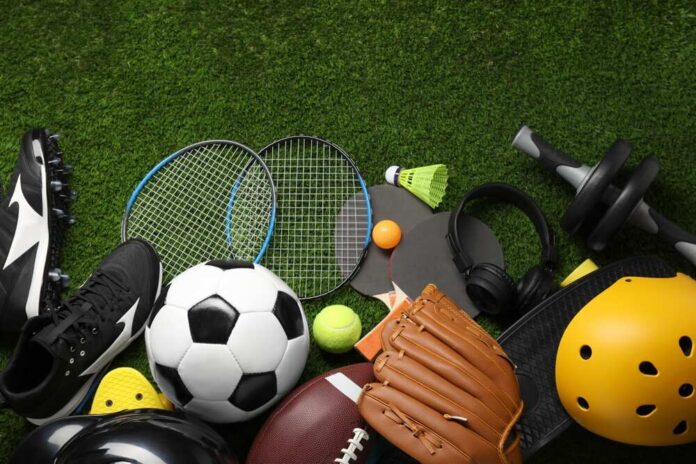 Different,Sports,Equipment,On,Green,Grass,,Flat,Lay Variety of sports equipment arranged on green grass