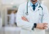 Universal Care Push Hits THIS Lib State A doctor in a white coat with a stethoscope standing with arms crossed