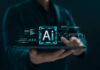 Person holding tablet with AI hologram display