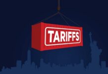 Price War Escalates: Latest Details Here Red shipping container labeled 'TARIFFS' suspended above a city skyline