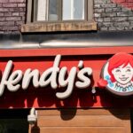 Wendy’s Giant Hits Court – Hundreds At Risk Wendy’s restaurant storefront sign with red-haired girl logo