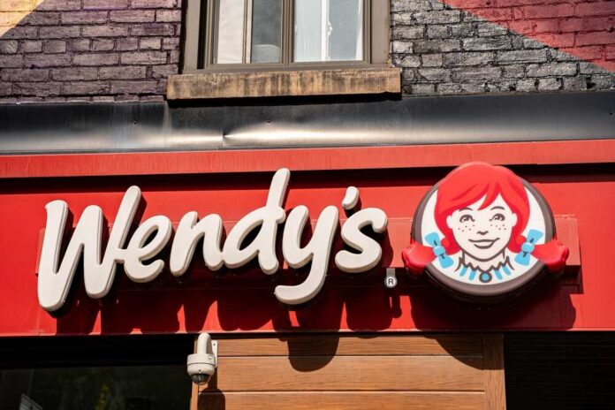 Exterior,View,Of,Wendy's,Restaurant,In,Toronto.,Toronto,,Canada, Wendy’s restaurant storefront sign with red-haired girl logo