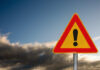 VIDEO: Miracle Rescue On Ice Island A triangular warning sign with an exclamation mark against a cloudy sky