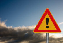 VIDEO: Miracle Rescue On Ice Island A triangular warning sign with an exclamation mark against a cloudy sky