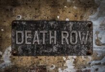 Weathered metal sign reading 'DEATH ROW' on a wall