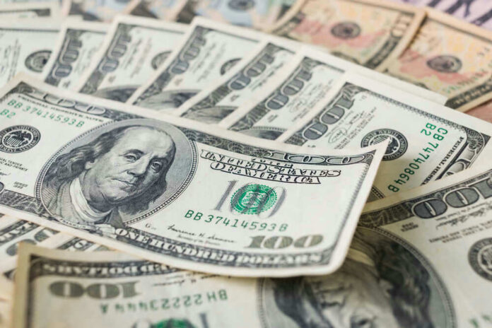 shutterstock_548542114 Stacks of various U.S. dollar bills.