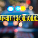 Elementary School Attacked — One Dead Police tape and lights at crime scene.