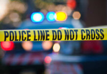 Police tape and lights at crime scene.