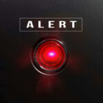 ALERT: Kratom Surfaces At Death Scenes Red alert light against black background, text ALERT.