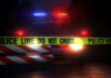 VIDEO: 12 Shot During 30 Seconds Of Gunfire Police car with flashing lights behind caution tape.