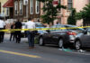 Parking Rage Kills Child At Football Park Police and crime scene tape on city street.