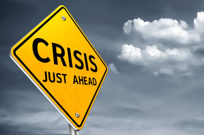 A yellow warning sign indicating a crisis ahead