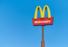 McDonald’s Villains Drop McDonald's restaurant sign against a clear blue sky