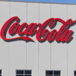 Red script logo on a white building facade