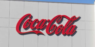 Red script logo on a white building facade