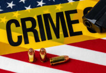 Kids Shot in Homecoming Chaos A gun and bullets on an American flag with a crime scene marker