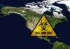 Ebola Lands In – Patient Dies North America map with biohazard warning triangle overlay