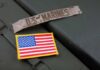 Marine Arrest Sparks Lockdown Military patches including a US Marines insignia and an American flag on a green surface