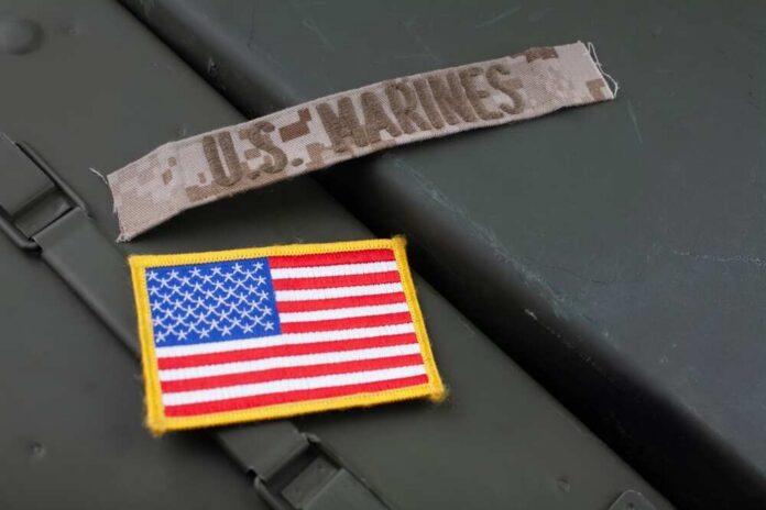 U.s.,Marines,Branch,Tape,With,National,Us,Flag,Patch,On Military patches including a US Marines insignia and an American flag on a green surface