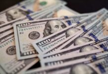 Close-up of scattered hundred dollar bills