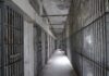Prison Breach Stuns America Empty prison corridor with barred cells on either side