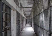 Prison Breach Stuns America Empty prison corridor with barred cells on either side