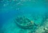 Mystery: Jars Map A Wreck An underwater scene featuring a shipwreck surrounded by fish and coral