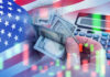 Stock Market Reaches Shocking Milestone USA flag calculator and hands holding dollars overlapping