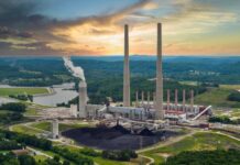 No Contamination? Then Why The Sirens Coal-fired power plant with tall smokestacks at sunset