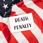 Execution Horror Stuns America Notebook with message on an American flag background