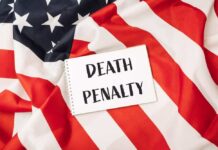Execution Horror Stuns America Notebook with message on an American flag background