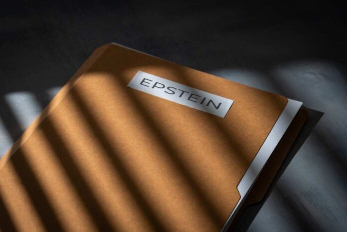 A brown folder with the name 'EPSTEIN' on it, partially illuminated by light and casting shadows
