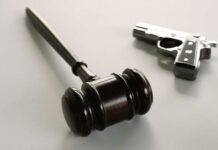 Bodycams vs Bullets: Feds On Trial wooden judge's gavel with a handgun in the background